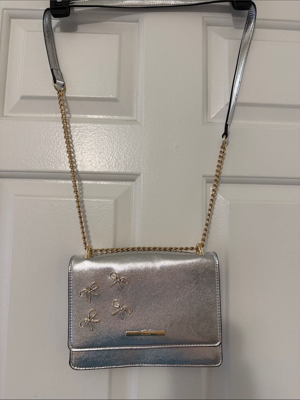 Aldo Metallic Silver Crossbody with Gold Chain & Bow Accents